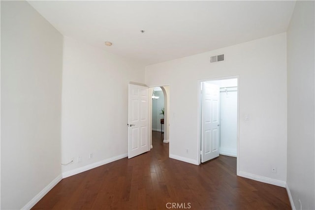 unfurnished bedroom featuring dark hardwood / wood-style flooring