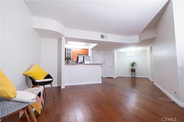 living room with dark hardwood / wood-style floors and a chandelier