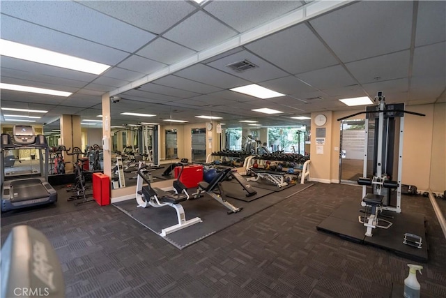 workout area featuring a paneled ceiling and carpet floors