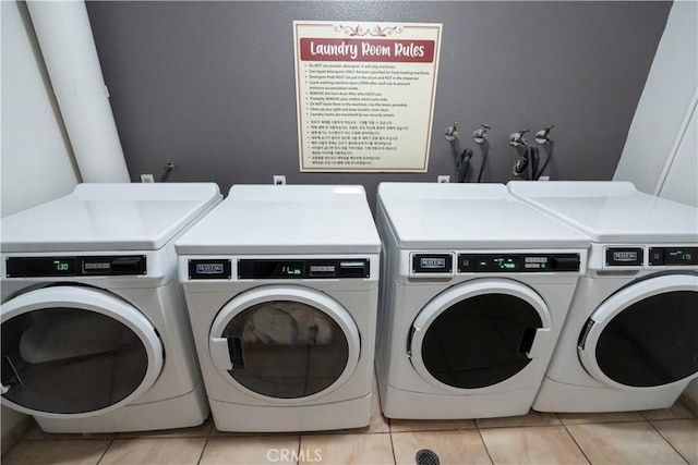 washroom with washing machine and dryer and light tile patterned floors