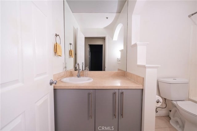 bathroom featuring tile patterned flooring, vanity, and toilet