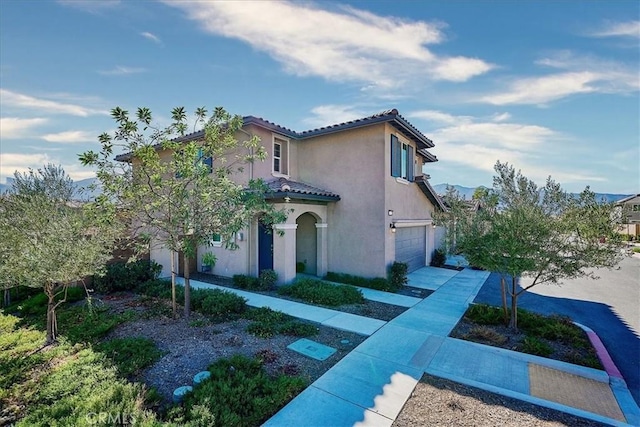 mediterranean / spanish house with a garage