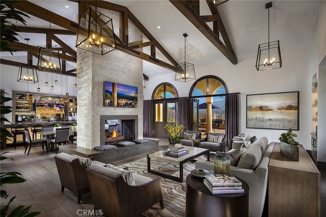 living room with a fireplace, beam ceiling, and high vaulted ceiling