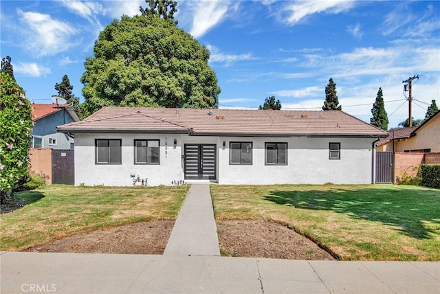 view of front of house with french doors and a front lawn