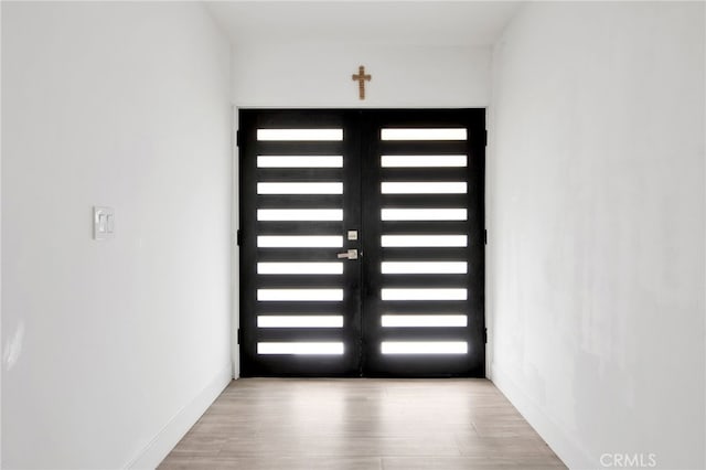 foyer featuring french doors and light hardwood / wood-style flooring