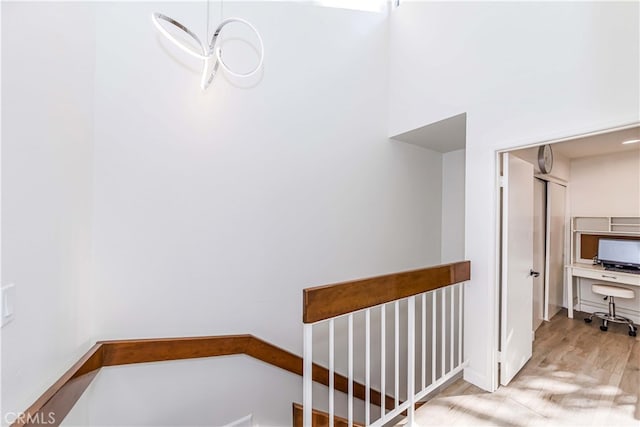 stairway with hardwood / wood-style floors