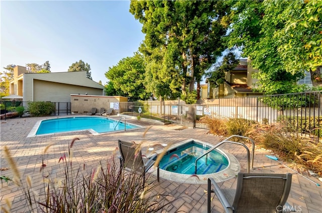 view of swimming pool featuring a patio area and a community hot tub