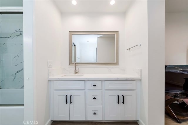 bathroom with vanity and a shower