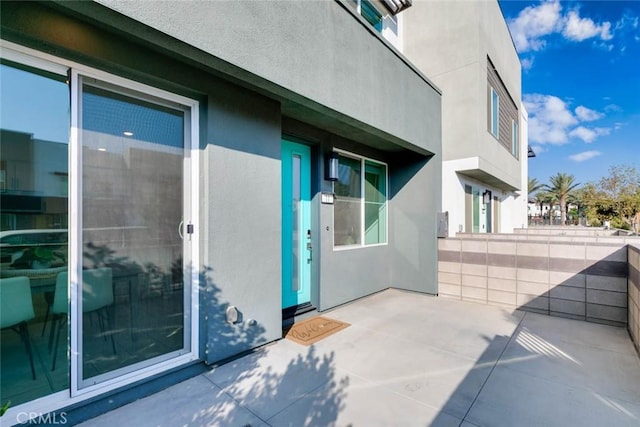 entrance to property featuring a patio area