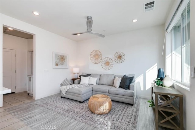 living room with ceiling fan and light hardwood / wood-style floors