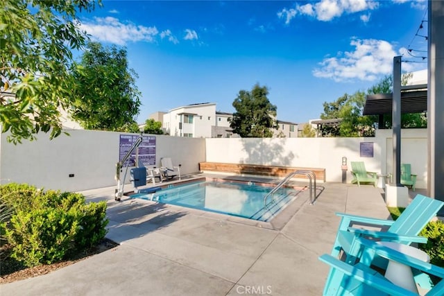 view of swimming pool with a patio and a hot tub