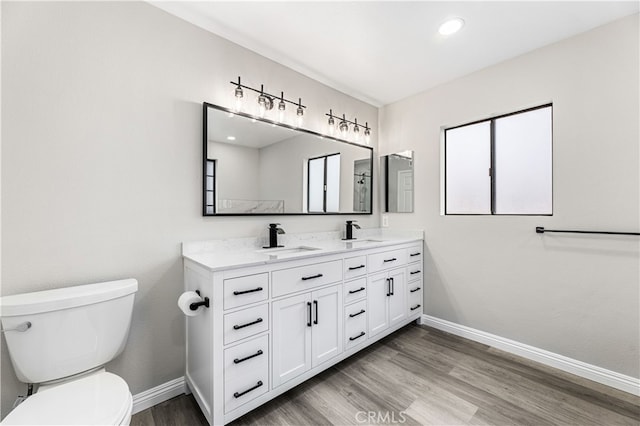 bathroom featuring vanity, toilet, and wood-type flooring