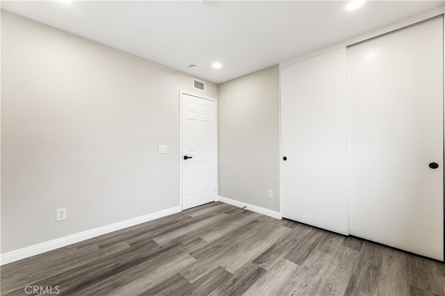 unfurnished room with wood-type flooring