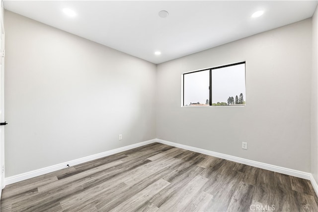 unfurnished room with hardwood / wood-style flooring