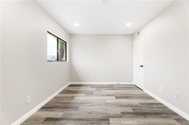 spare room featuring wood-type flooring