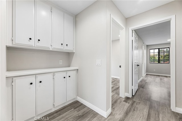 corridor with light hardwood / wood-style floors