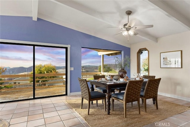 dining area featuring vaulted ceiling with beams, ceiling fan, light tile patterned floors, and a mountain view