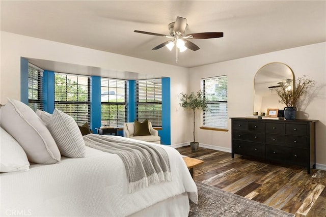 bedroom with multiple windows, ceiling fan, and dark wood-type flooring