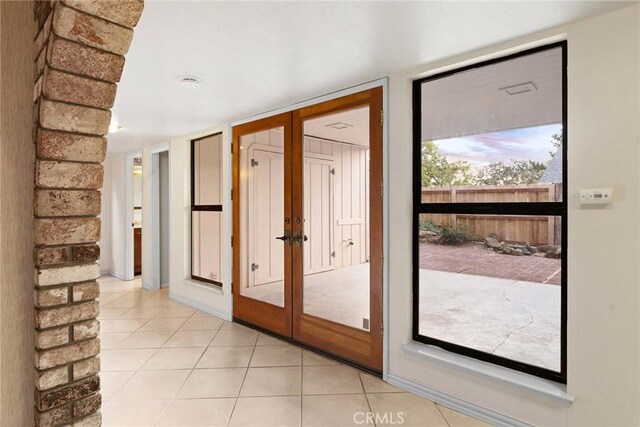 entryway featuring french doors and light tile patterned floors