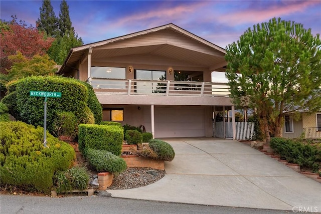 view of front of home with a balcony and a garage