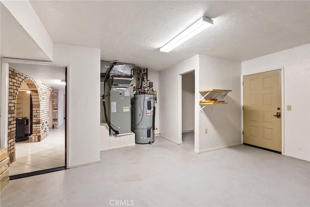 basement featuring heating unit, a textured ceiling, and water heater