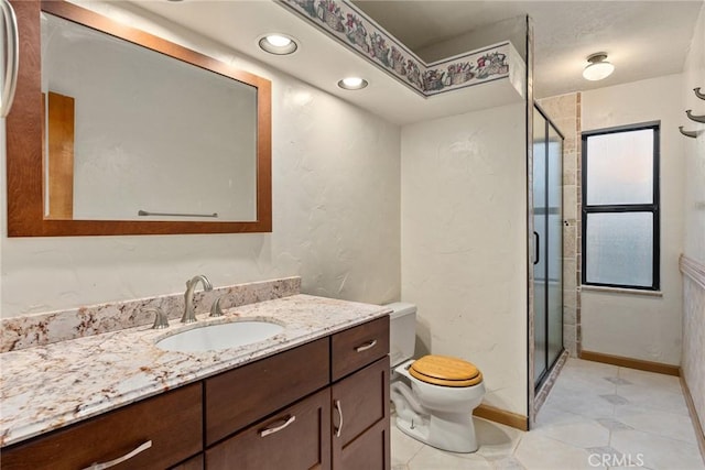 bathroom featuring tile patterned flooring, vanity, toilet, and an enclosed shower