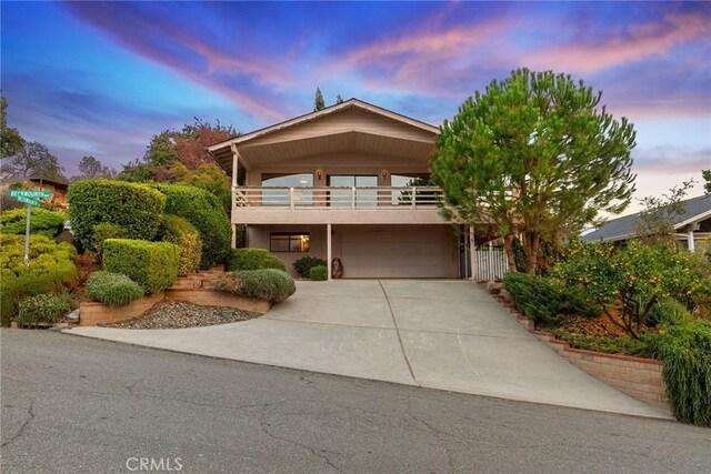 view of front of home with a garage and a balcony