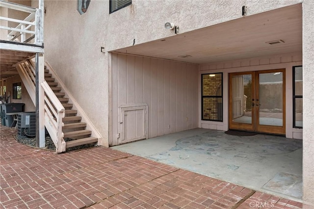 view of patio / terrace featuring french doors and cooling unit