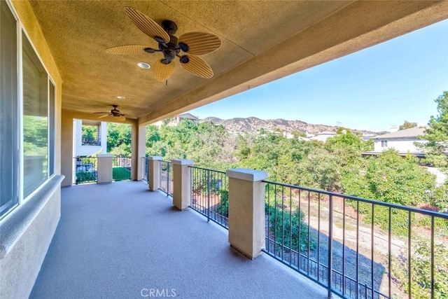 balcony with a mountain view and ceiling fan