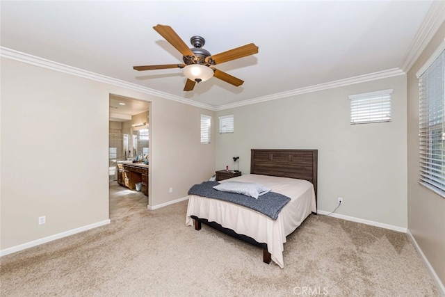 carpeted bedroom featuring ceiling fan, ensuite bath, and ornamental molding