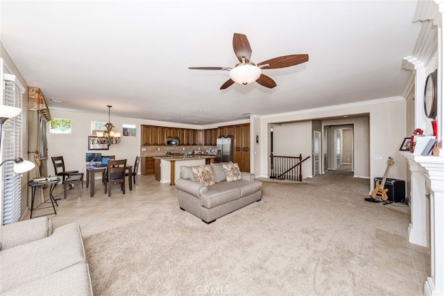 carpeted living room with ceiling fan with notable chandelier and crown molding