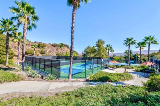 view of tennis court with a mountain view