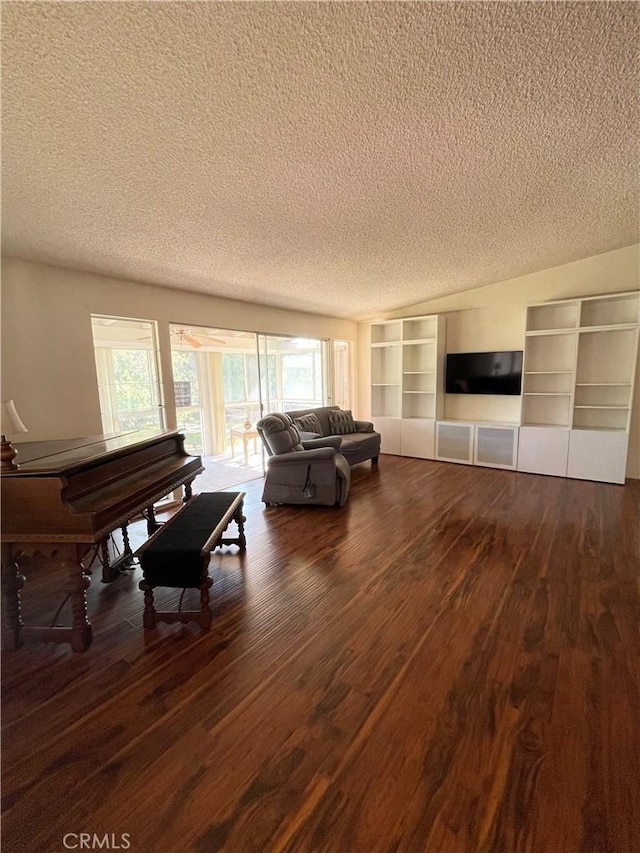 living room featuring dark hardwood / wood-style flooring and a textured ceiling