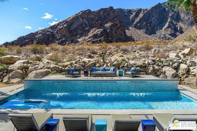 view of swimming pool featuring a mountain view and a patio area