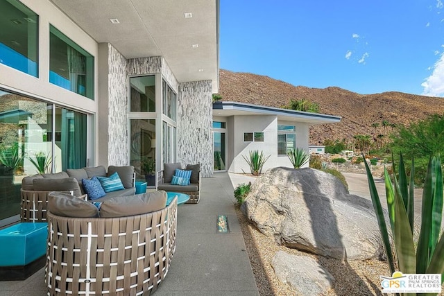 view of patio / terrace featuring outdoor lounge area and a mountain view