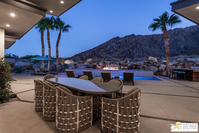 patio terrace at dusk with a mountain view