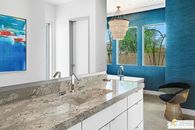 bathroom with a chandelier and vanity