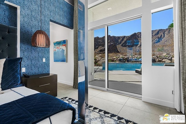 bedroom with a mountain view and access to outside