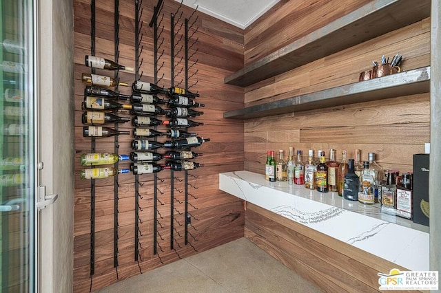 wine room featuring wooden walls