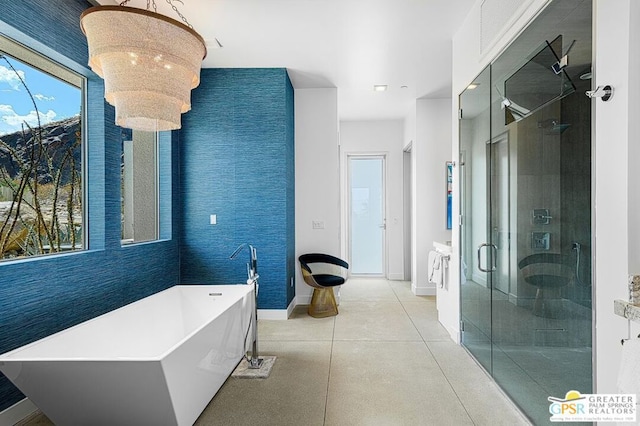 bathroom featuring a notable chandelier and independent shower and bath