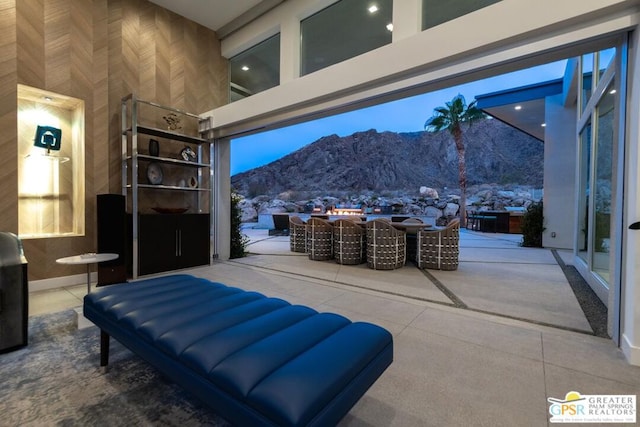 snow covered patio with a mountain view