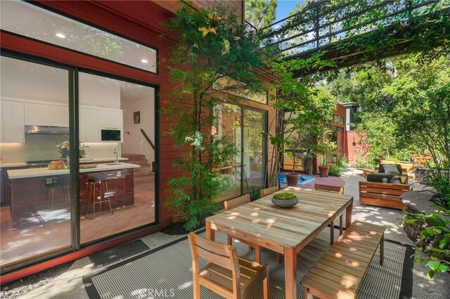 deck featuring a patio area and a pergola