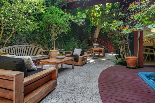 view of patio featuring outdoor lounge area, grilling area, and a wooden deck