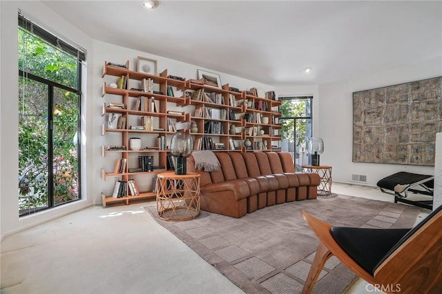 living area with carpet, visible vents, and recessed lighting