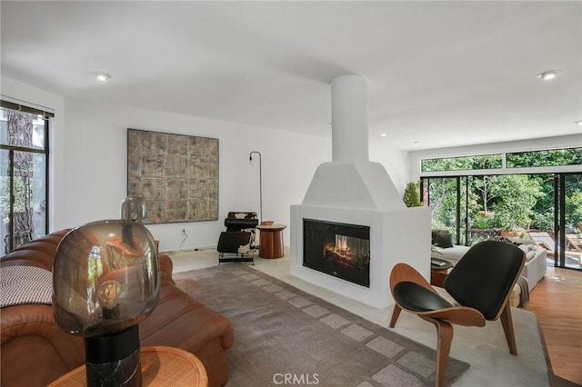 living room with light wood-type flooring and a large fireplace