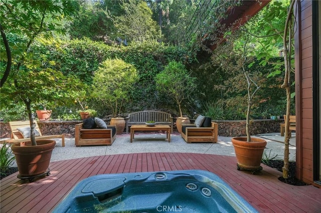 view of patio with a deck, outdoor lounge area, and hot tub deck surround