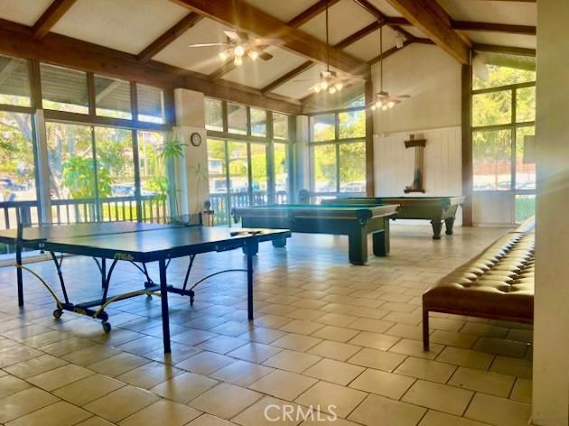 game room with ceiling fan, a healthy amount of sunlight, and high vaulted ceiling