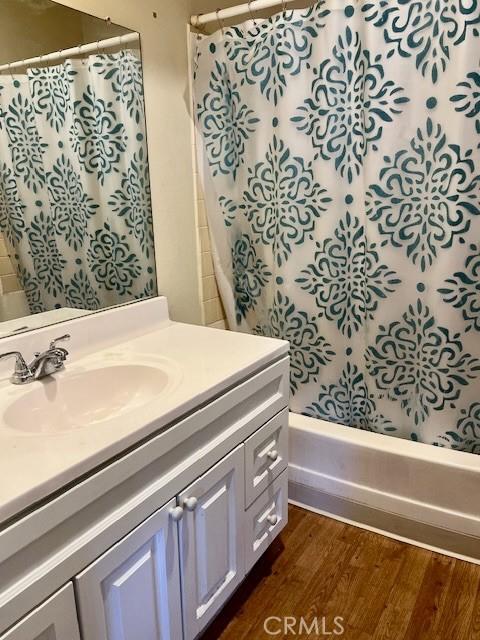 bathroom with hardwood / wood-style flooring and vanity