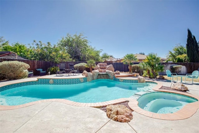 view of swimming pool featuring an in ground hot tub and a patio