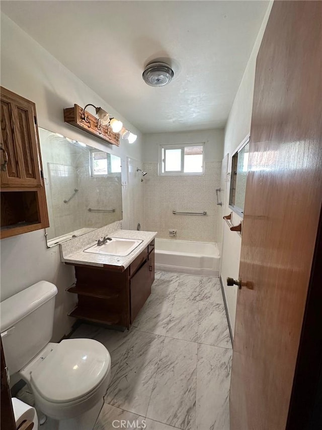 full bathroom featuring vanity, toilet, and tiled shower / bath